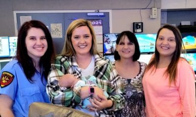 Paramedic Anna Cain, dispatcher Paige Cook with baby Nola, grandmother Dana Hearn and mother Hannah Hearn