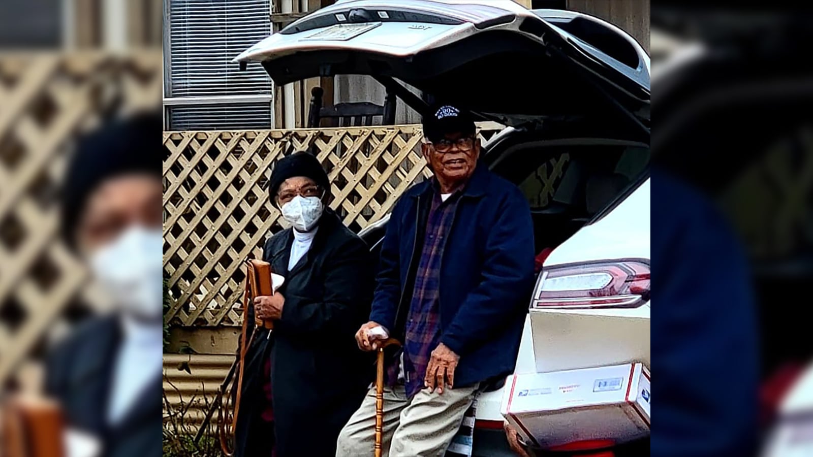 Willy Harris Jr. watches as a parade of cars drive by to celebrate his 90th birthday Photo Credit: David Day
