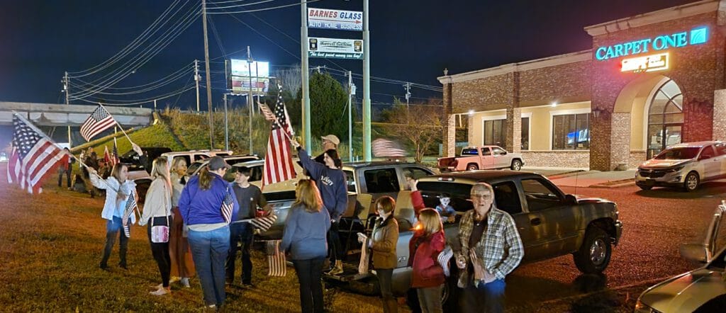 Part of the group in front of Carpet One/Barnes Glass. Photo by David Day