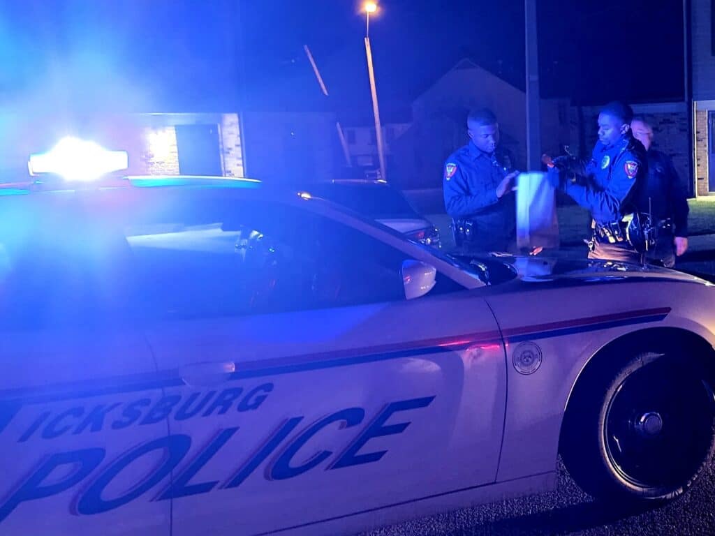 The orange ceramic knife being placed into evidence. Photo by David Day