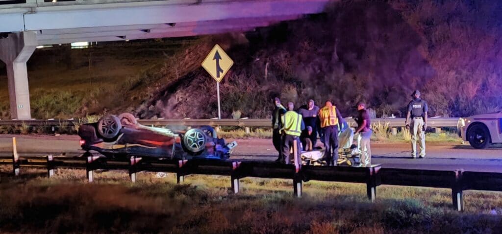 A green Mustang with multi-colored stripes is overturned on Clay at I-20. Photo by David Day