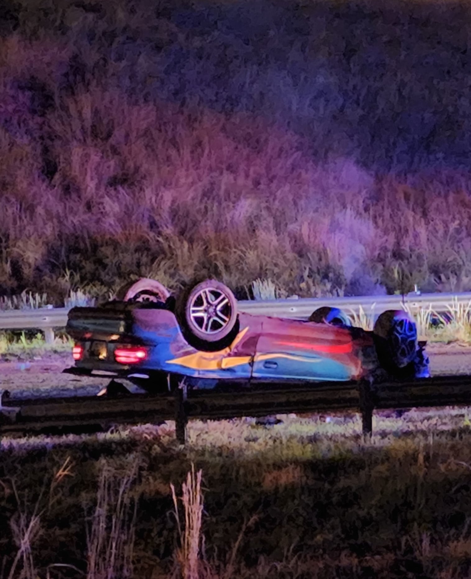 A green Mustang with multi-colored stripes is overturned on Clay at I-20. Photo by David Day