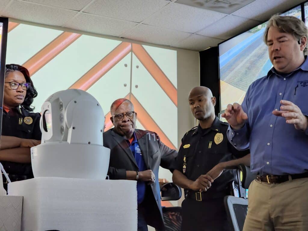 Chief Jones, Mayor Flaggs, Lt. Smith and Bryan Lagarde look at one of the high end cameras. Photo by David Day
