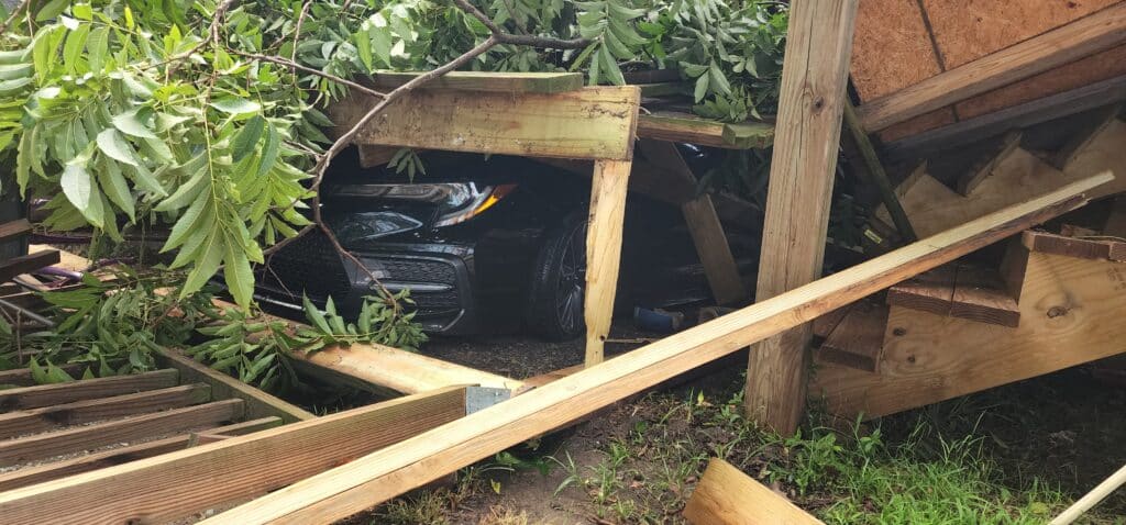 A new car trapped unter the debris. Photo by David Day