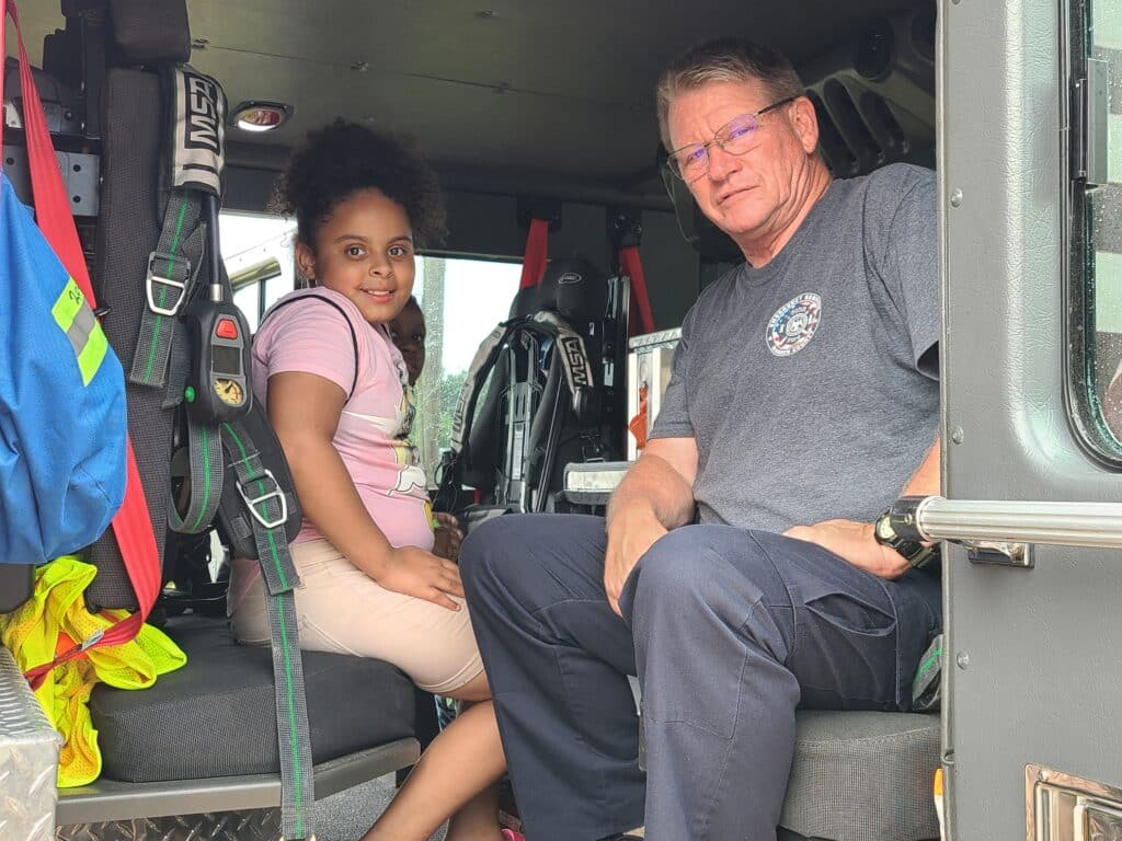 Jeff Riggs with the fire department with kids