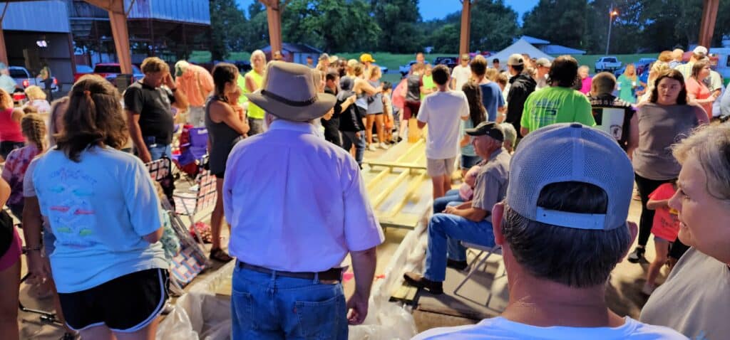 The anxious crowd gathers around the race track. Photo by David Day
