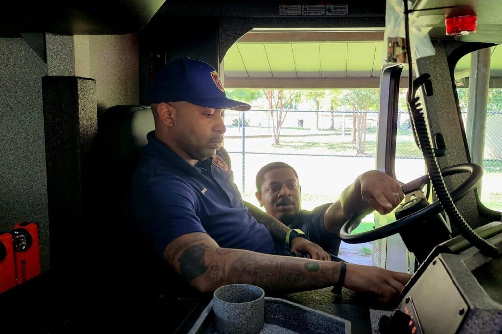 Lt. Walter Beamon and Capt Vincent McRavin inspect the new Engine 7. Photo by David Day