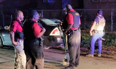 Police officers discuss the crime scene. Photo by David Day