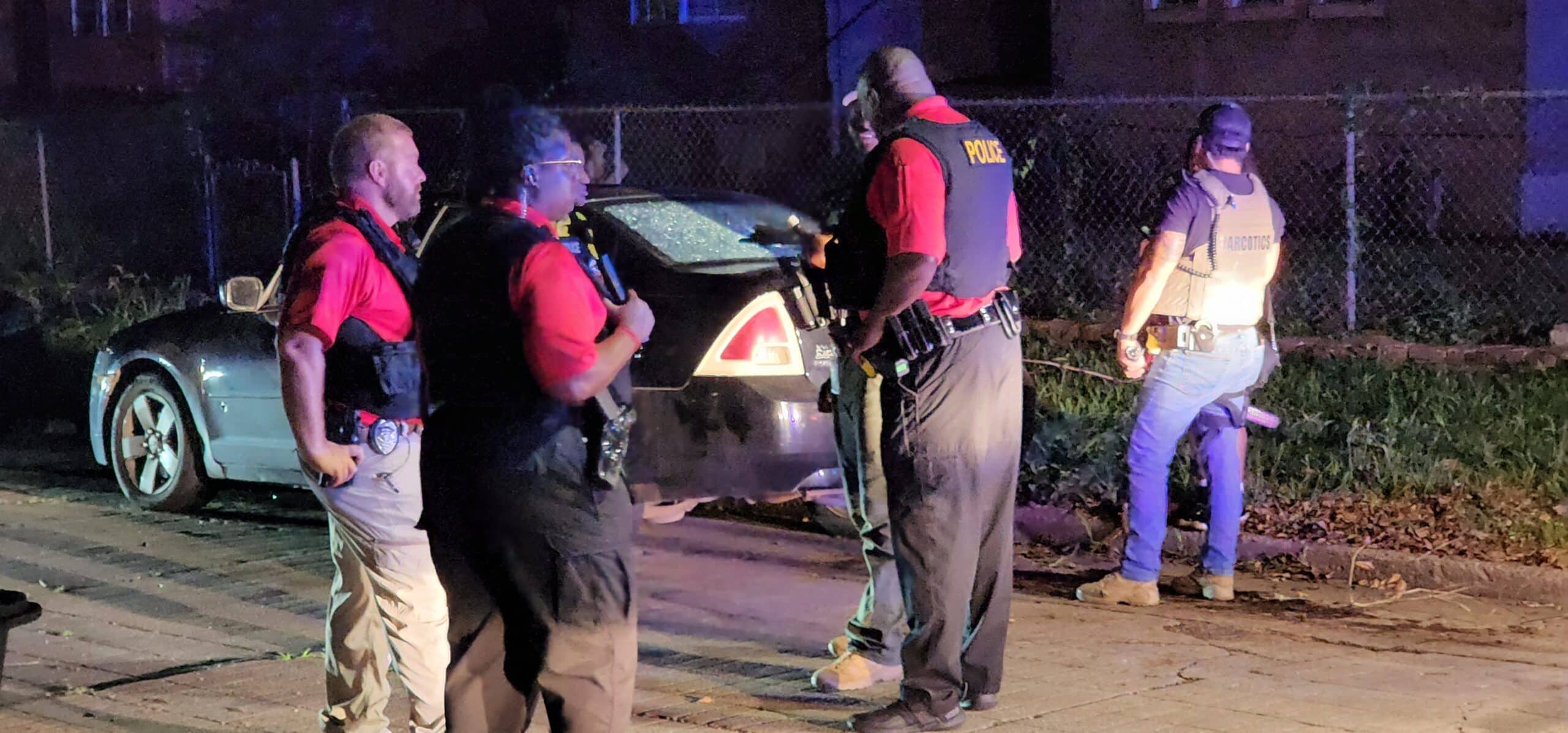 Police officers discuss the crime scene. Photo by David Day