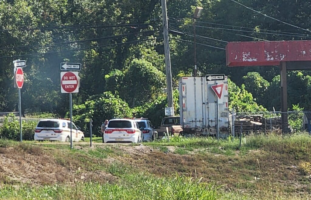 Warren County Sheriff's Deputites recover the older gold Dodge pickup. Photo by David Day
