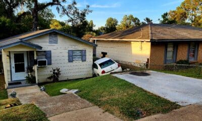 vehicle rolls down hill into house