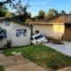 vehicle rolls down hill into house