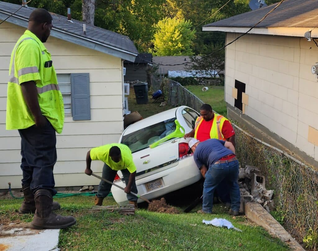 vehicle rolls down hill into house