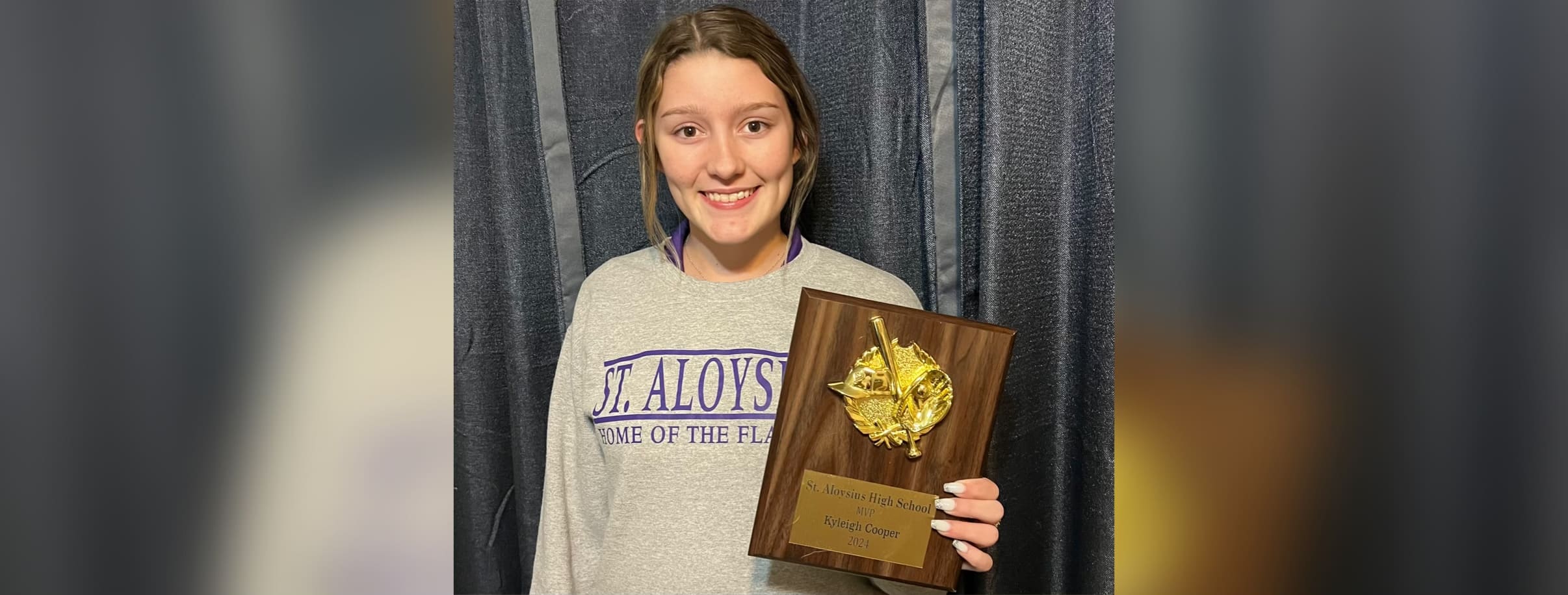 Kyleigh Cooper holding plaque