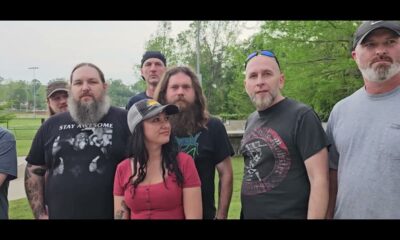 Group of musicians and event organizers posing outdoors, promoting Muddy River Madness Vicksburg.